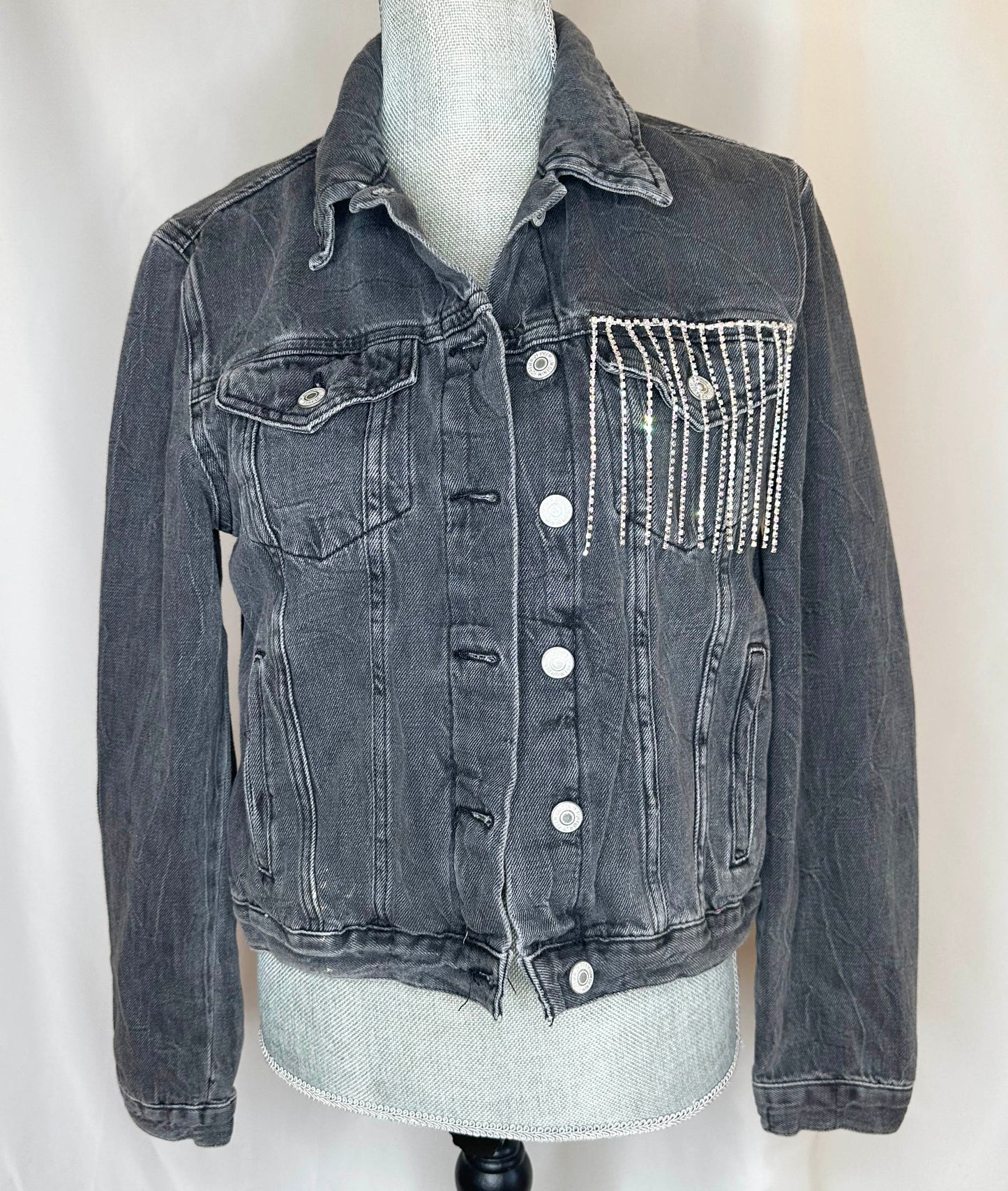 Black fringe "Cowboys & Tequila" Womens Denim Jacket Front Side featuring double button pockets and rhinestone waterfall detailing on left pocket.