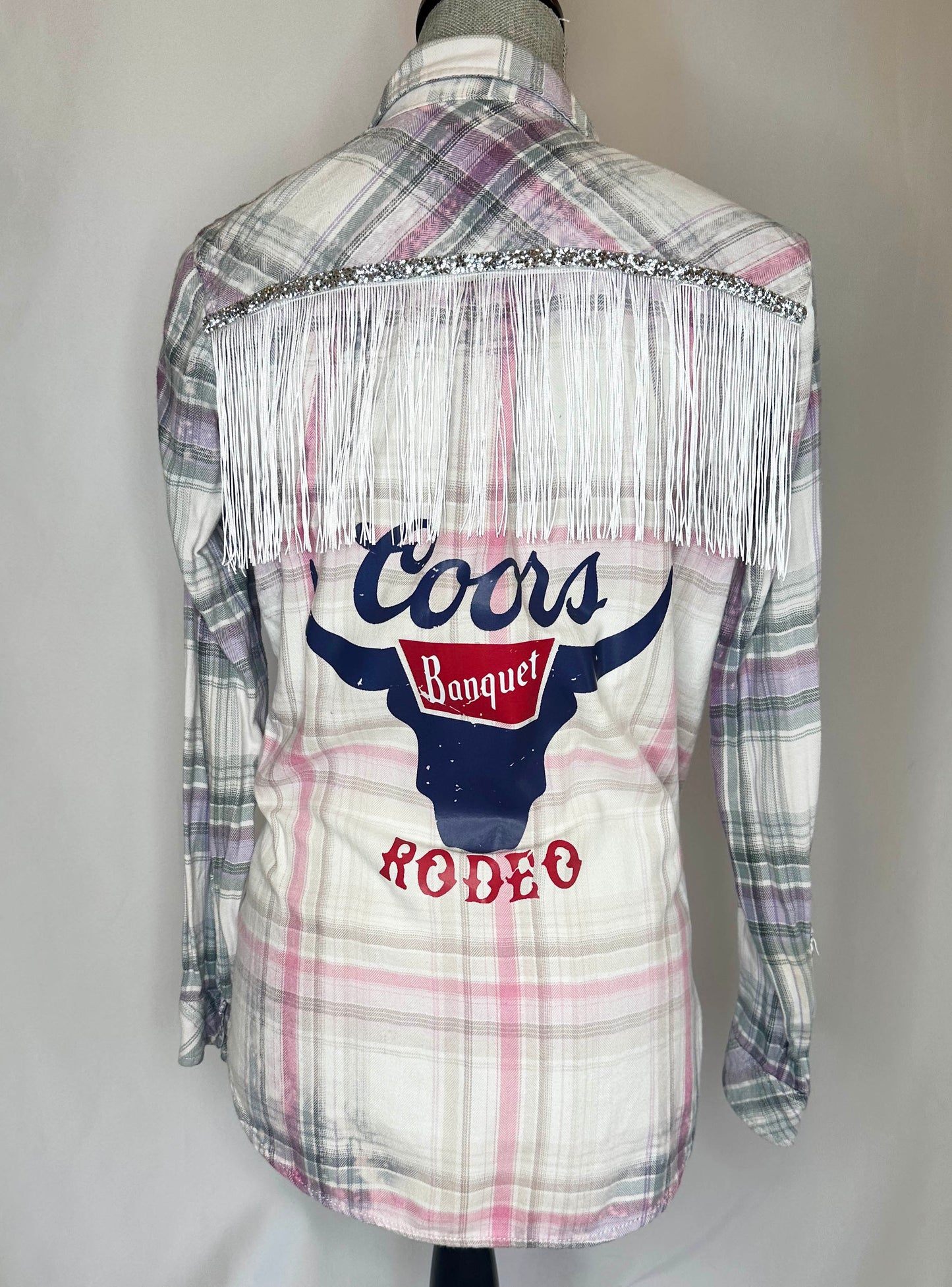 "Coors Rodeo" Womens Flannel Back Side featuring silver glitter detailing with white fringe and printed design.