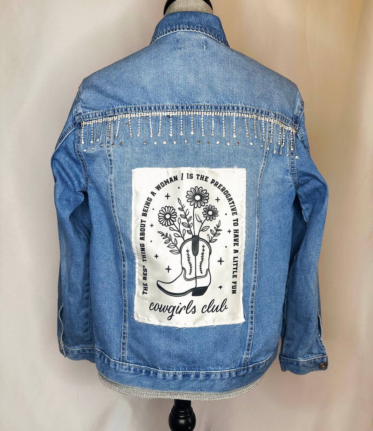 "Cowgirl Club" Womens Medium Denim Jacket Back Side featuring rhinestone detailing and satin patch "The thing about being a woman is the perogative to have a little fun"