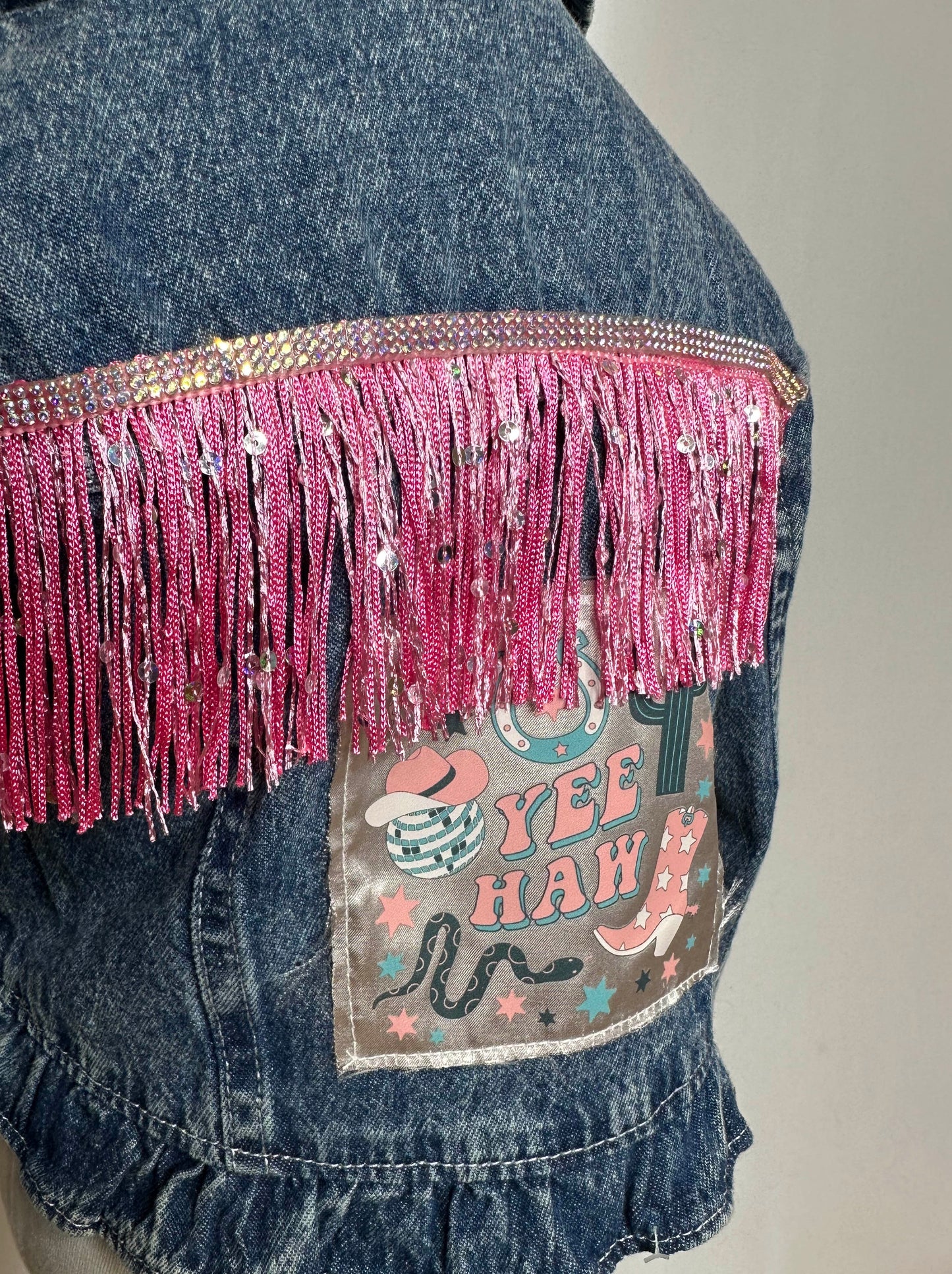 "Yee Haw" Pink Fringe Kids Denim Jacket Detailing - featuring rhinestone detailing, sequin pink fringe and yee haw satin patch.