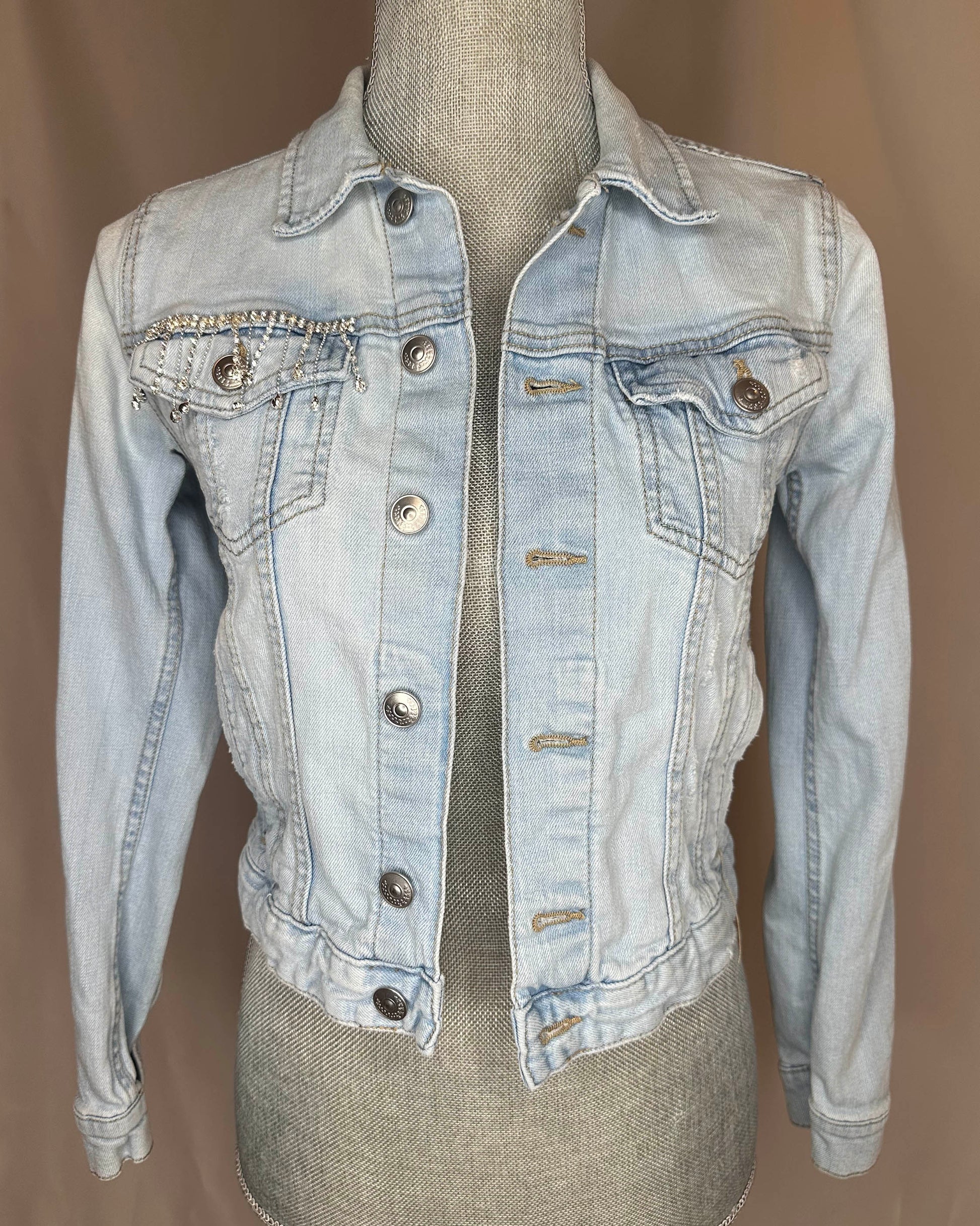 Fringe "Cowgirl club"  Womens Light Denim Jacket Front Side featuring rhinestone waterfall detailing on right front pocket.