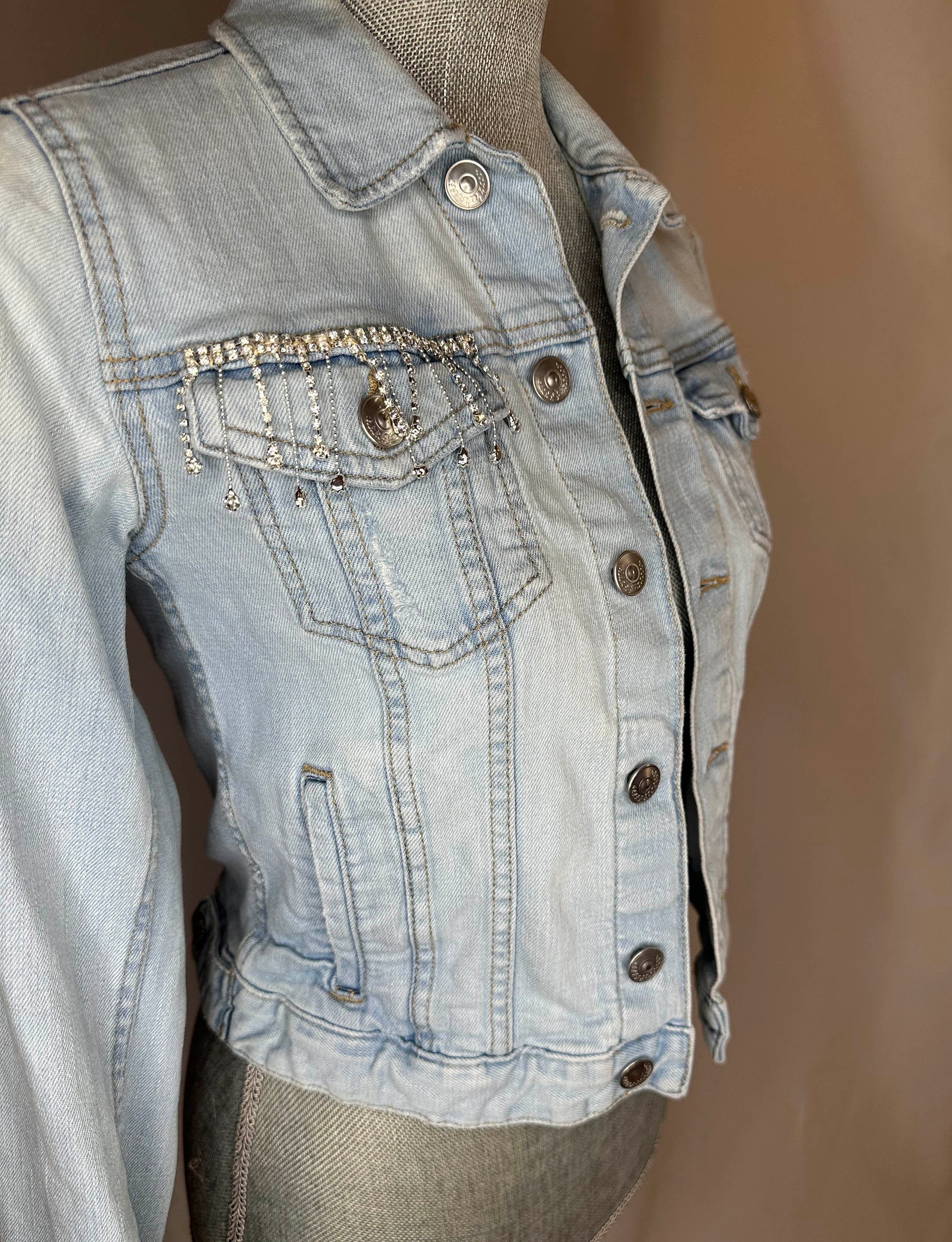 Fringe "Cowgirl club"  Womens Light Denim Jacket Front Angle featuring rhinestone waterfall detailing on right front pocket.
