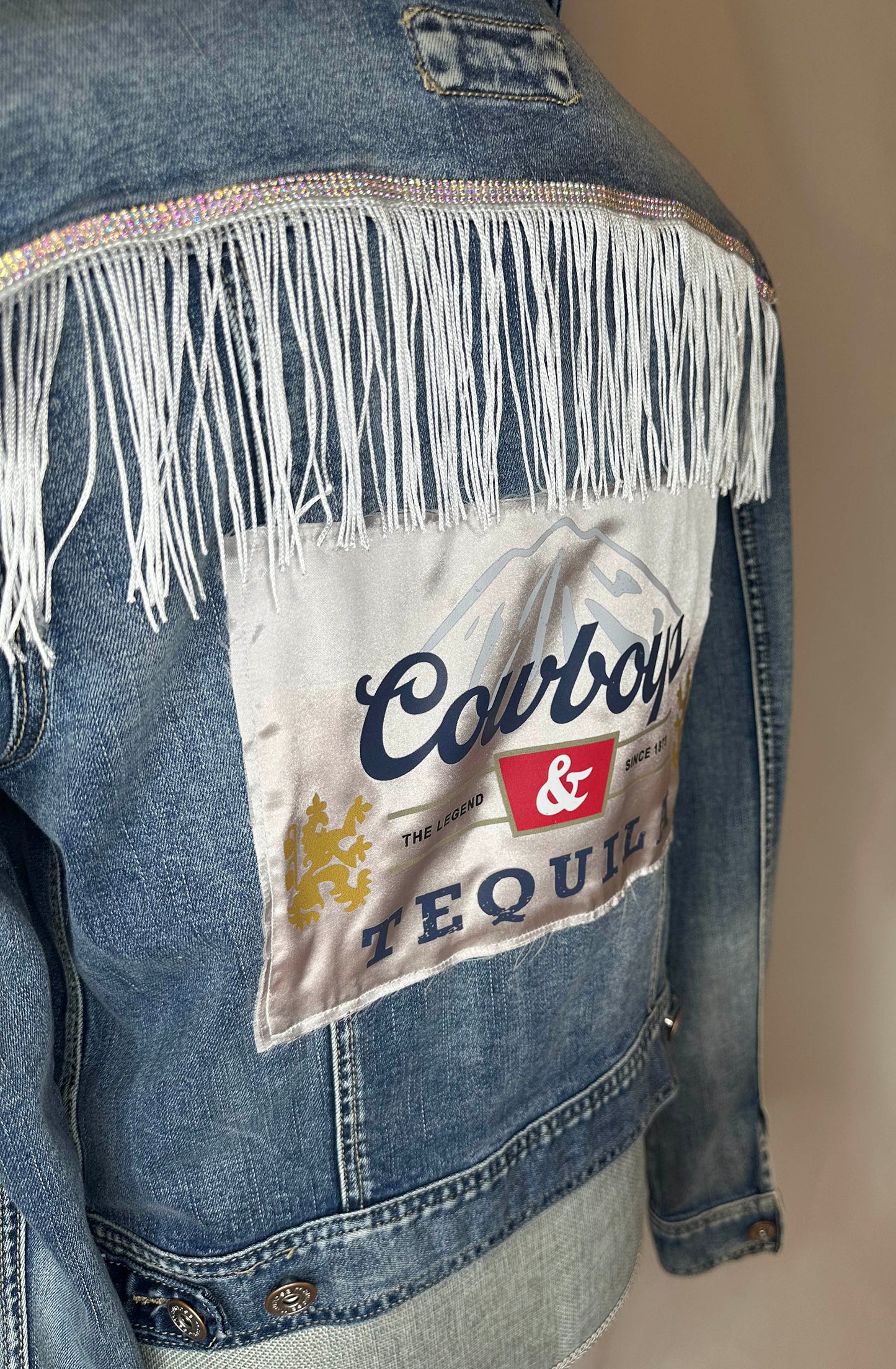 White_Fringe_Cowboys_Tequila_Womens_Denim_Jacket_Side with rhinestone and fringe white detailing 