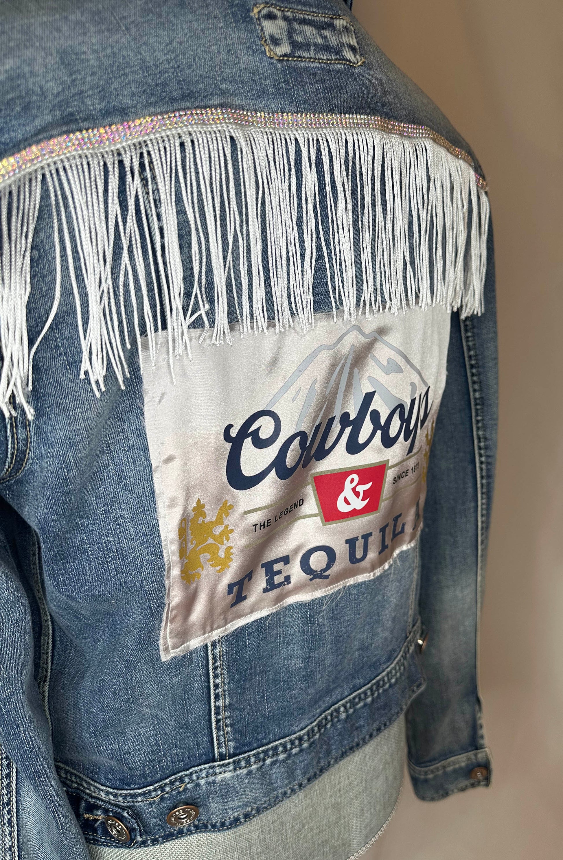 White_Fringe_Cowboys_Tequila_Womens_Denim_Jacket_Side with rhinestone and fringe white detailing 